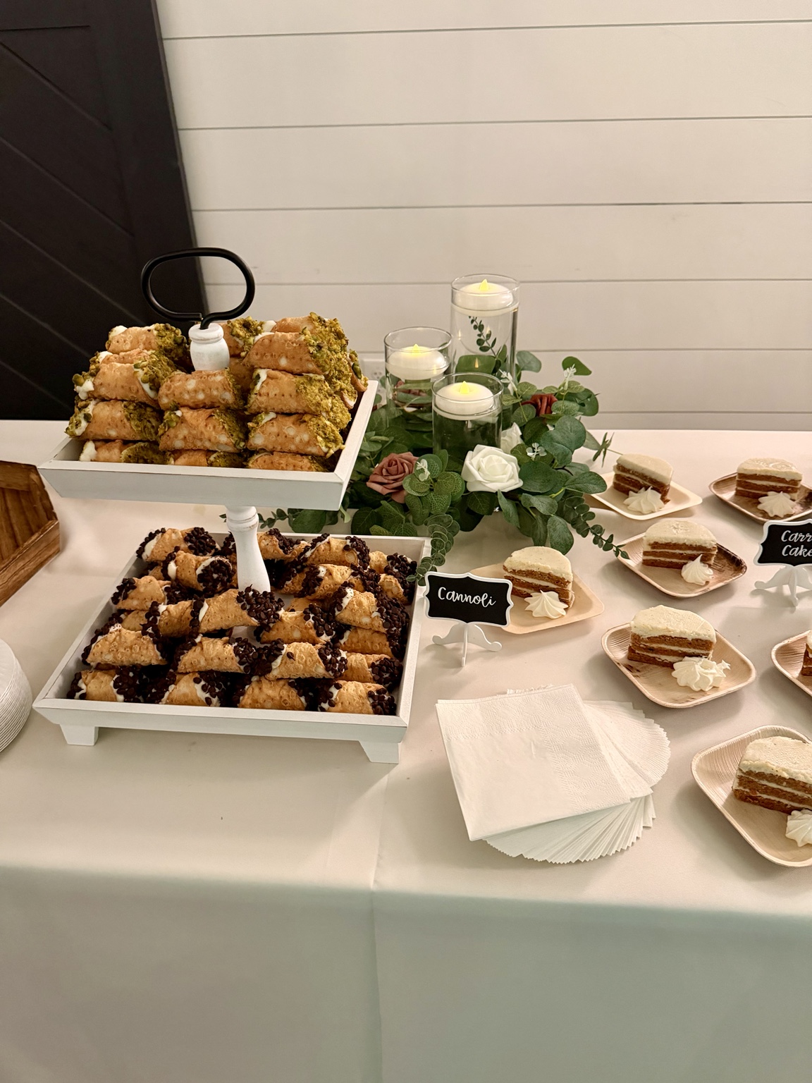 Cannoli and individual carrot cakes arranged with flowers and candles