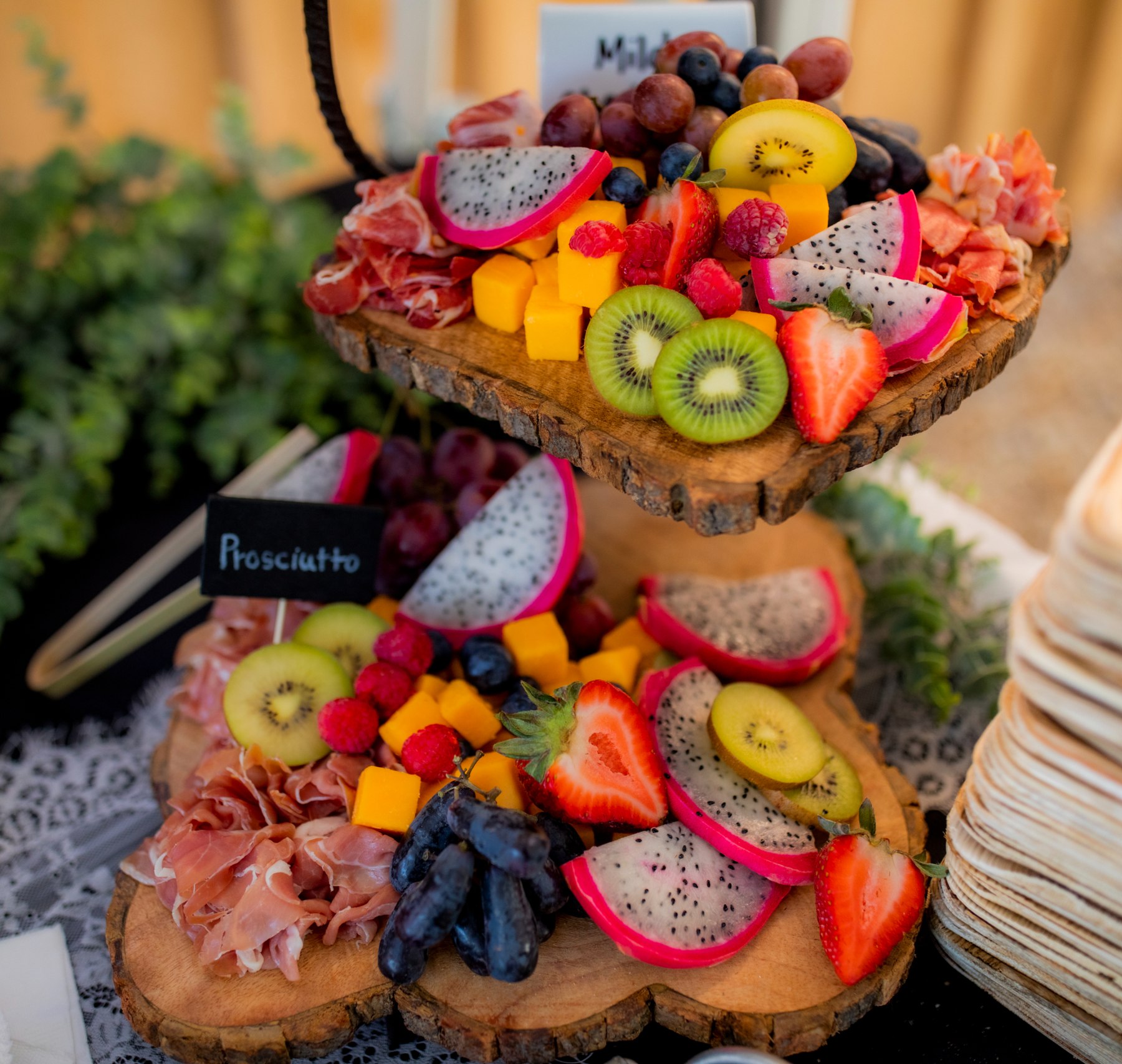 A tiered City Moose grazing display with fresh fruit, cheese, and prosciutto